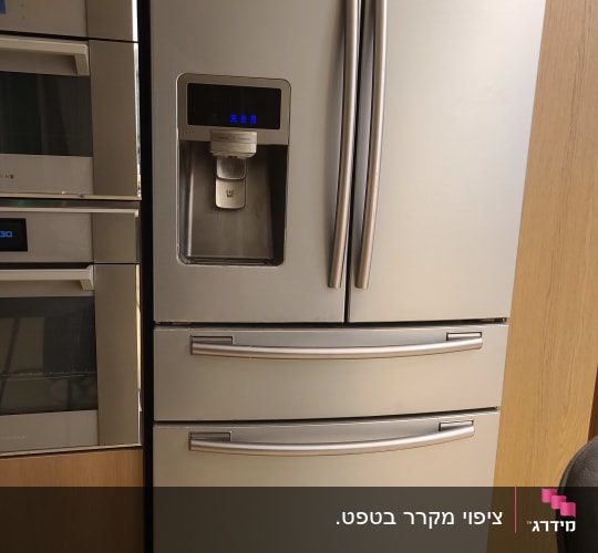 מקרר כסוף עם ידיות ארוכות ודלתות כפולות